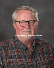 Studio portrait of Peter Stewart, Database Administrator for the Office of Research and Economic Dev