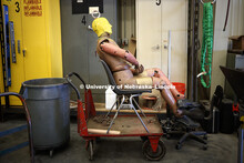 A crash test dummy awaits its turn in the facility garage. Test of bull-nose barrier for use in medi