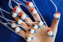 Graduate student Elizabeth Hoffman hand is covered in sensors, which uses air pulses to create a sti