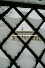 Love Library cupola framed in the snow covered lattice work of the fence. January 12, 2019. 