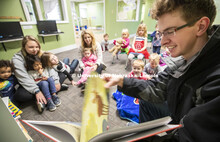 Thomas Kerr, freshman in accounting from Hastings, reads to children Monday morning at the Foundatio