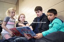 Will Gallagher, freshman in business from Kenesaw, NE, reads at the YMCA of Lincoln-Northeast as par