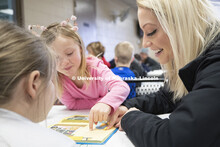 Jordyn Senstock, freshman in Nutrition and Health Sciences, reads at the YMCA of Lincoln-Northeast a