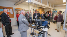 Nebraska's Christian Binek (center) leads the NU Regents and other university officials in a tour of