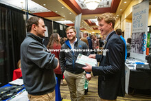 Jared Muhlbach and Carson Hicks talk with a recruiter from Farmers Cooperative at the STEM Career Fa