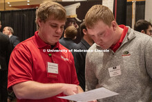 Benjamin Barlean speaks with a recruiter from Ag Valley C0-OP at the STEM Career Fair (Science, Tech
