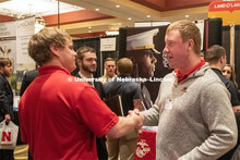 Benjamin Barlean speaks with a recruiter from Ag Valley C0-OP at the STEM Career Fair (Science, Tech