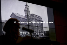 Kay Logan Peters is silhouetted by a photo of University Hall as she gives a special Nebraska Lectur