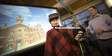 Jane Green tries out a virtual reality reconstruction of Nebraska Hall under the watchful guidance o