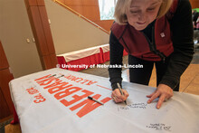 Donde Plowman, Executive Vice Chancellor and Chief Academic Officer, signs one of the four Alumni N1