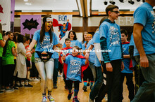 Dance Marathon attendees form a tunnel for the Miracle kids to run through. Miracle kids shown with 