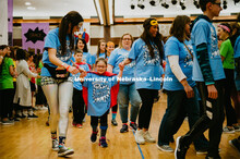 Dance Marathon attendees form a tunnel for the Miracle kids to run through. Miracle kids shown with 