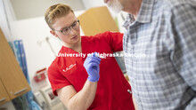Josh Gasper, UNMC nursing student, gives a flu shot. Influenza Vaccines. Virology research. February