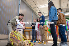 Lincoln Children's Zoo giraffe keeper Nikki Shemanski (left) talks with students (from left) Pin Hao