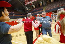 Tristin Smith from Curtis, NE, runs through a tunnel walk of high-fives at the FFA signing ceremony 