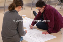 Grace Stallworth (right), project coordinator for Worlds of Connections, plays a network science gam