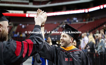 Ross Barron exchanges high fives with faculty members who lined the processional. 2019 Spring Gradua