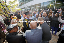 Friends, family and fellow Alpha Phi Alpha fraternity brothers form a circle around Davielle Phillip