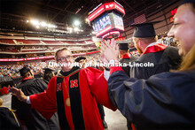 Chancellor Ronnie Green high fives graduates as they progress into the arena. Undergraduate commence