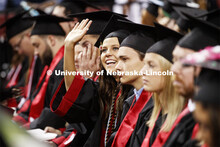 A young woman waves to her family. Undergraduate commencement at Pinnacle Bank Arena, May 4, 2019. 