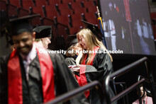 Lindsey Amen accepts her college of journalism diploma. Undergraduate commencement at Pinnacle Bank 