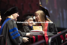 Lindsey Amen accepts her college of journalism diploma. Undergraduate commencement at Pinnacle Bank 