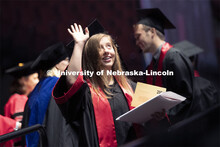 Lindsey Amen waves after receiving her college of journalism diploma. Undergraduate commencement at 