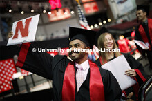 Khaled Saad AlSubaie waves to family and friends as he walks off stage Saturday. Undergraduate comme