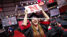 Hailey Lehms celebrates her CoJMC degree as she returns to her seat. Undergraduate commencement at P