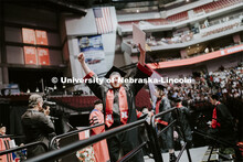 Jacob Andrews gestures to family and friends after receiving his College of Business diploma. Underg