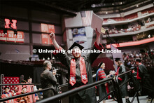 Jacob Andrews gestures to family and friends after receiving his College of Business diploma. Underg