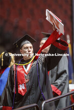 Jackson Grasz gestures to family and friends after receiving his College of Business diploma. Underg
