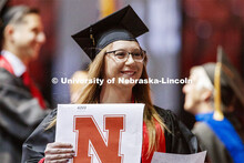 Abby Kile smiles at family and friends after receiving her College of Business diploma. Undergraduat