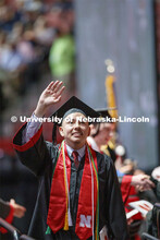 Helmuth Krische gestures to family and friends after receiving his College of Business diploma. Unde