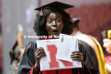 Aguel Lual gestures to family and friends as she walks off stage with her Fine and Performing Arts d