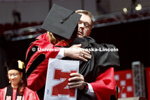 Chancellor Ronnie Green takes a moment to hug his youngest daughter, Regan, after he presented her w