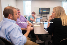 Aaron Johnson (left), assistant professor of teaching, learning and education, brainstorms with LPS 