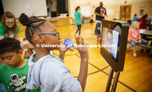 Ani'a Morris-Gordon interacts with Soham Patel, a UNL computer science major, who is using Beam tech