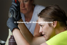 Kayla Vondracek processes an algae-filled water sample at the Niobrara Valley Preserve as Professor 