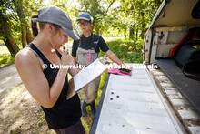 Kayla Vondracek and Sydney Kimnach look over their data after sampling a site. Jessica Corman, assis