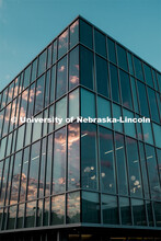 The sunsetting sky is reflected in the windows of Cather Dining Hall. July 25, 2019. 