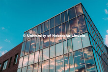 The sunsetting sky is reflected in the windows of Cather Dining Hall. July 25, 2019. 