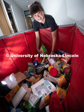 Justina Clark, Director of Undergraduate Research delivers donated items to the Husker Pantry. Her b