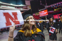Taylor Knickerbocker shows off her diploma to family and friends as she leaves the arena following c