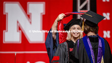 Amy Mantz smiles at her advisor Angie Pannier as she receives her doctoral hood. 2019 Summer Commenc