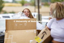 Ella Bowman tries to steer a cart full of belongings for her sister, Brook, as she helps older siste
