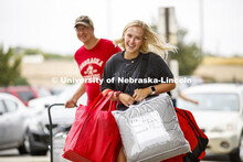 Stephanie Rottmann of Castle Rock, Colorado, carries an arm-load of belongings into Schramm Hall Res