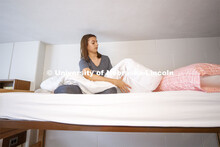 Adrianna Meiergerd, a freshman from Austin, Minnesota, makes her bed after moving everything into he