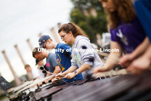 Percussion Section Leader Alyssa Soppe and the rest of the Cornhusker Marching Band front ensemble p