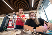 East campus residents from Massengale Hall craft wall hangings and make fruit on a kebobs, meeting o